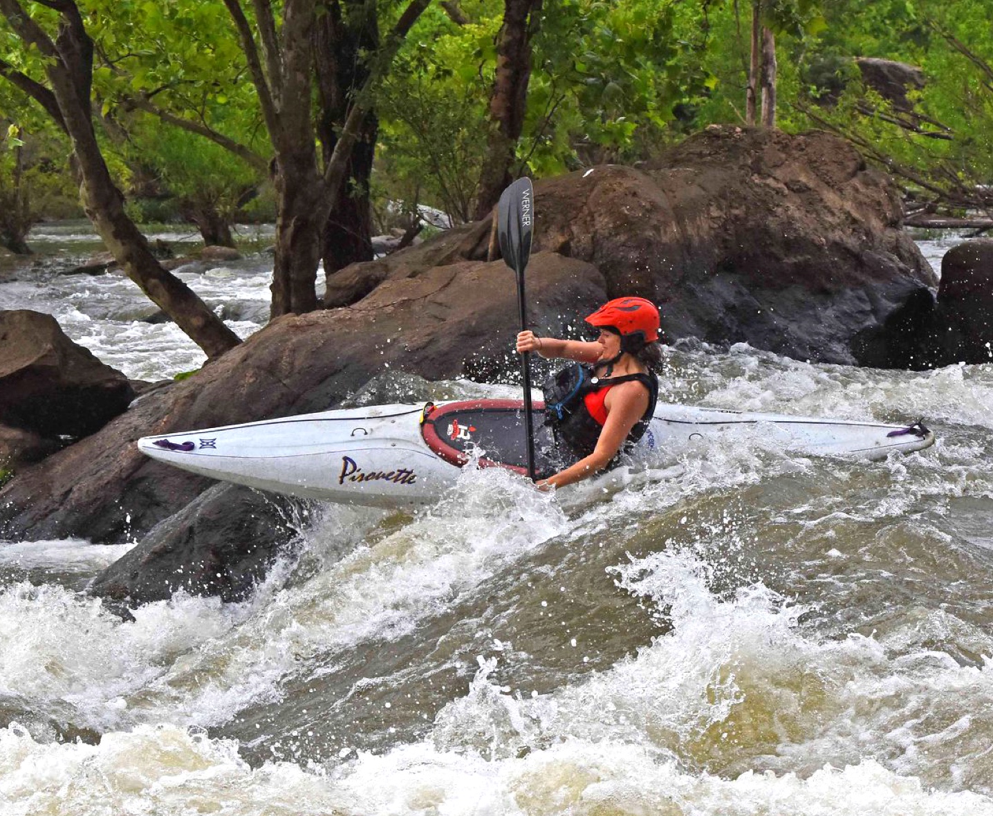 Richmond Sports Massage — Woman kayaking in river on drop